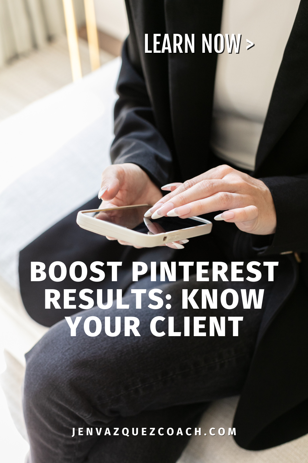 Women in a black pantsuit scrolling on a screen colored cell phone and create sweater under suit jacket.  Boost Pinterest Results: Kow Your Ideal Client